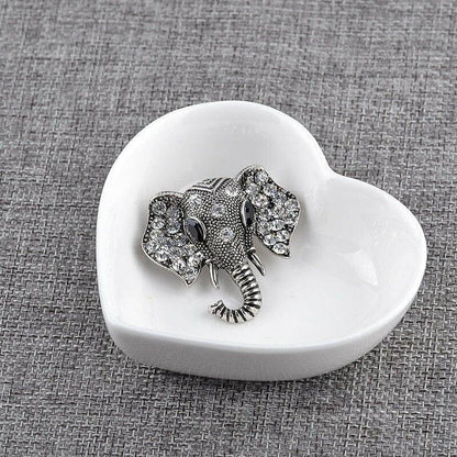Silver elephant crystal brooch on a white heart-shaped dish
