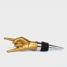 Gold hand bottle stopper with chrome collar and black ribbed insert