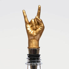 Gold peace-sign bottle stopper with black rubber ring and chrome collar