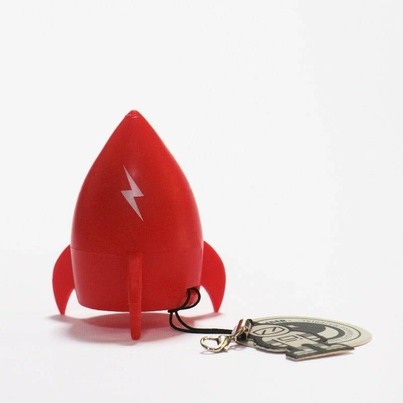 Red rocket pencil sharpener with lightning graphic on the nose cone; keychain charm nearby.