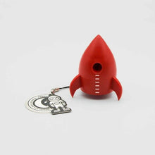 Red rocket pencil sharpener with keychain charm, showing the front sharpening hole.