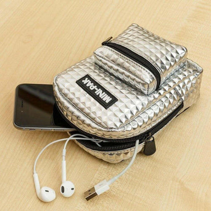 Silver mini backpack with top flap and front zip pocket, open to show contents
