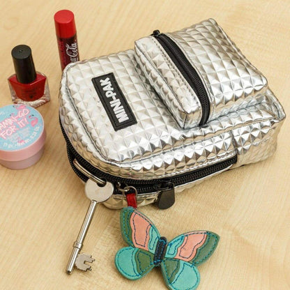 Silver mini backpack with key clip and butterfly charm on black lanyard strap
