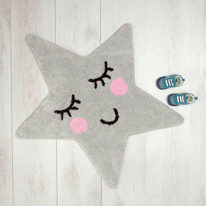 Grey star rug with cartoon eyelash pattern and pink dot cheeks on floor