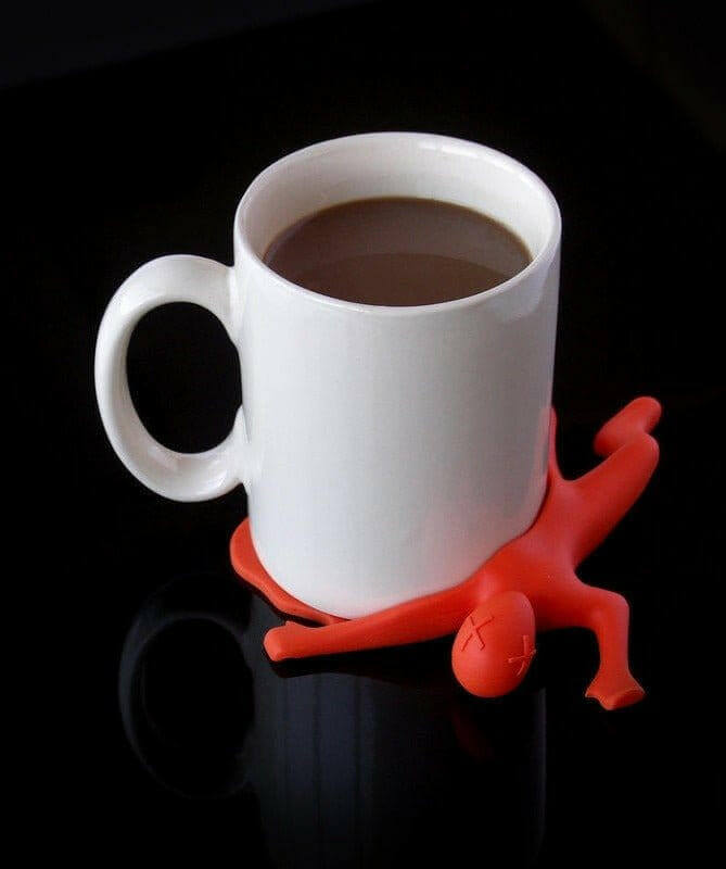 Silicon drink coaster orange splat character around the base of a white mug
