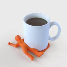 Silicon drink coaster orange splat character beside a light blue mug