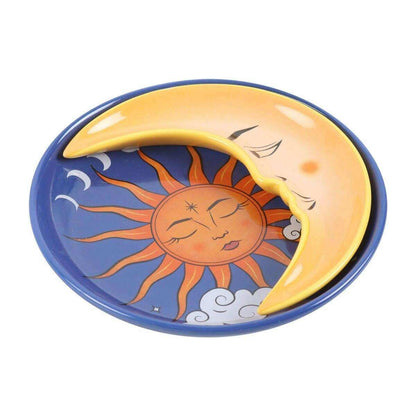 Round celestial trinket dish with blue background, orange sun face, and yellow crescent moon