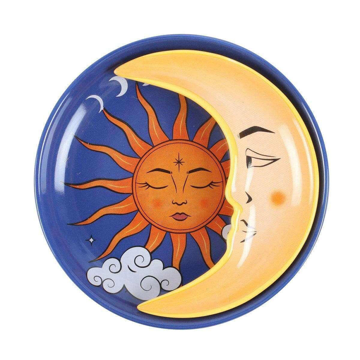 Round celestial trinket dish with blue rim, orange sun face, crescent moon, and tiny stars