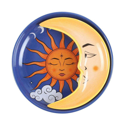 Round celestial trinket dish with blue rim, orange sun face, crescent moon, and tiny stars