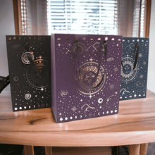 Celestial gift bags set: black, purple, and blue paper bags with moon and star print.