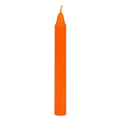 Orange pillar candle with a visible wick top
