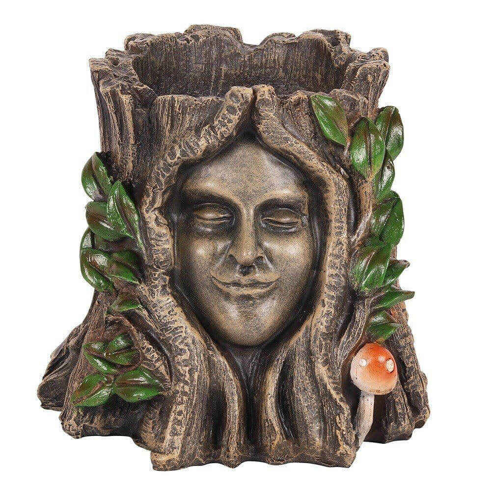 Decorative plant pot with bronze face, green leaves and small red mushroom detail