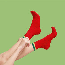 Watermelon fruit-themed socks, red with seed speckles and green-striped cuff