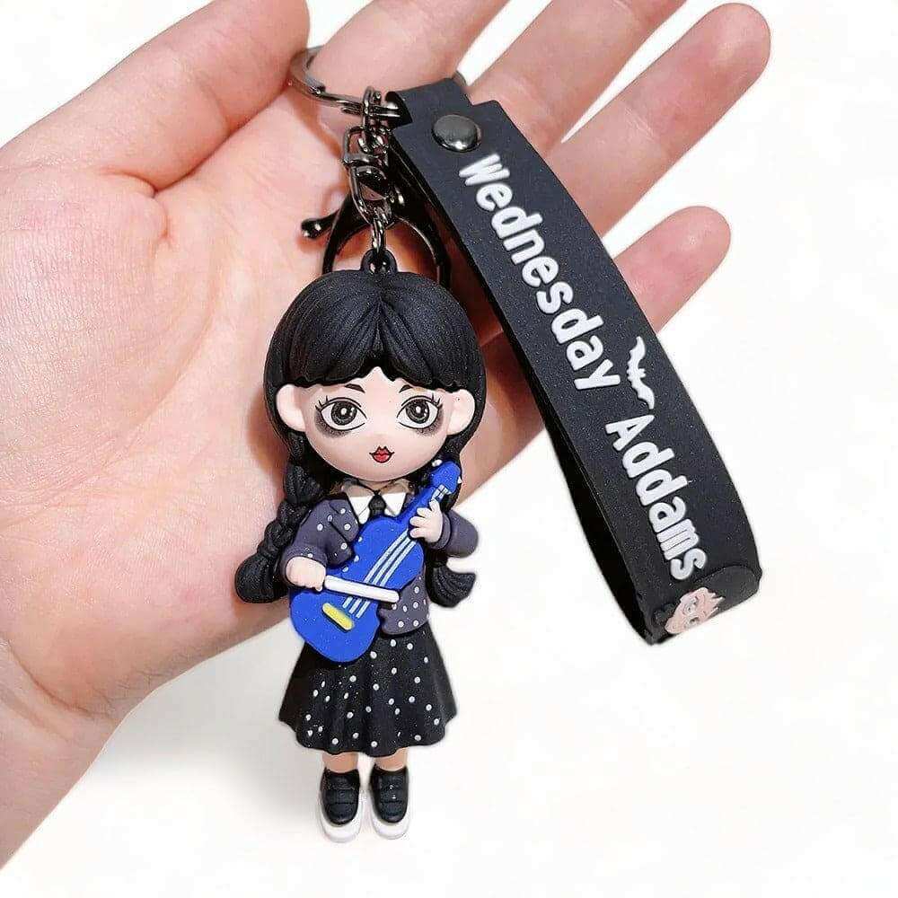 3D keyring charm with Wednesday-style doll holding blue violin and black "Wednesday Adams" strap