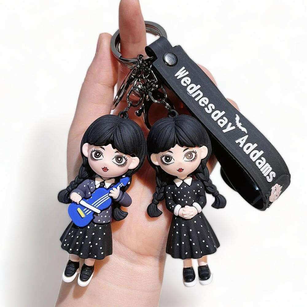 3D keyring charm with two Wednesday-style doll figures and black clasp strap