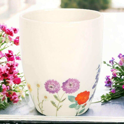 White ceramic plant pot with multicolor wildflower print and purple blooms