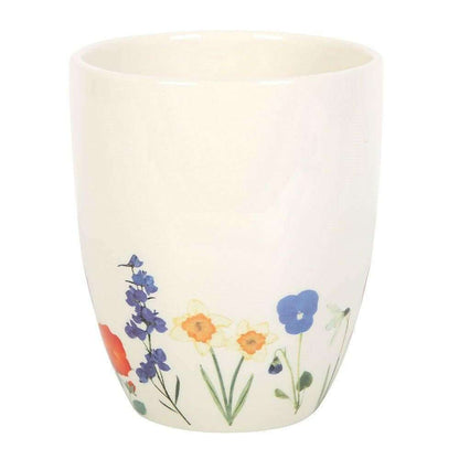 White ceramic plant pot with blue flowers and orange blossom wildflower print