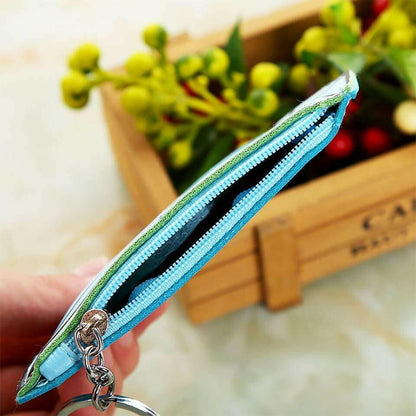 Blue coin purse with zipper closure and metal keyring, side view